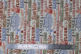 Flat swatch farmhouse text fabric (white barnboard style background with tossed red, blue, and black text allover "Strawberries" "Farmhouse" etc. and small graphics related to farm)
