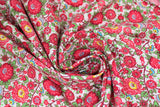 Swirled swatch Pink Peonies fabric (white fabric with busy tossed floral and wispy stems allover in red and green with blue and yellow accents)