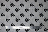 Flat swatch Pirate Ship fabric (light grey fabric with tossed black ship outlines with skull and cross bone flags)
