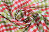 Swirled swatch pink and green plaid fabric (white fabric with gingham style lines of pink, red, and green)