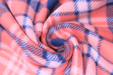 Swirled swatch coral plaid fabric (pale orange/red fabric with diagonal plaid lines in navy and white)