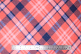 Flat swatch coral plaid fabric (pale orange/red fabric with diagonal plaid lines in navy and white)