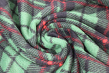 Swirled swatch Christmas plaid fabric (medium green fabric with diagonal black and red plaid lines thick medium size)