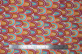 Flat swatch Primary Rainbows fabric (white fabric with tightly packed abstract drawn style rainbows in pale shades: yellow, magenta, peach/coral, burnt orange)