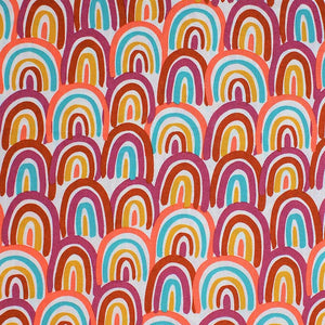 Square swatch Primary Rainbows fabric (white fabric with tightly packed abstract drawn style rainbows in pale shades: yellow, magenta, peach/coral, burnt orange)