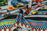 Print "Race Car Border Stripe" from the Turbo Speed collection, twisted to show drape and texture.