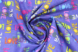 Swirled swatch text print fabric in shine bright (multicoloured "LOVE" on blue)
