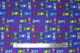 Flat swatch text print fabric in shine bright (multicoloured "LOVE" on blue)