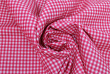 Swirled swatch gingham and plaid printed fabric in pink gingham