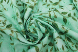 Swirled swatch flower & plant print fabric in golden leaves (on green)