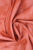 Swirled swatch near solid print fabric in orange