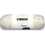 A ball of Caron Simply Soft Tweeds yarn in white shade with brown tweed flecks