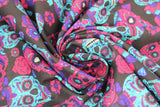 Swirled swatch Black/Pink/Green sugar skulls fabric (black fabric with medium sized tossed pink and teal green sugar skulls with pink, teal green and purple tossed floral allover)