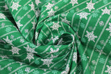 Swirled swatch Green fabric (green fabric with tossed white and green snowflakes in various sizes and styles with white lines/stripes)