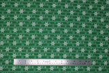 Flat swatch Green fabric (green fabric with tossed white and green snowflakes in various sizes and styles with white lines/stripes)