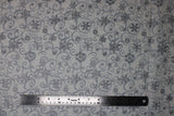 Flat swatch Silver fabric (white fabric with tossed grey snowflakes allover with lots of grey swirl shapes and silver metallic/sparkle accents)