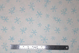 Flat swatch winter printed fabric in Blue Snowflakes on Cream