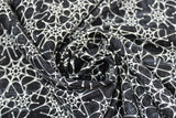 Swirled swatch Spiderwebs fabric (black fabric with subtle grey distressed look marks and busy tossed white spiderwebs allover)