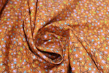 Swirled swatch Shooting Stars on Orange print fabric