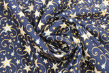 Swirled swatch shooting gold fabric (black fabric with small and medium sized white and yellow/gold stars with swoopy shooting star like designs behind)