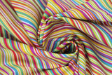 Swirled swatch colourful fabric (vertical rainbow coloured stripes in abstract shapes and order allover with white)