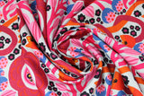 Swirled swatch summer themed fabric in Colourful Flowers (red/orange)
