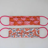 Front and back view of mask with pink elastic ear loops (orange mask with faint pink tie die floral look design)