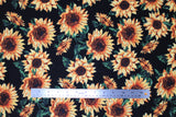 Flat swatch sunflowers fabric (black fabric with small and medium tossed yellow and black sunflowers with dark green leaves/greenery)