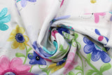 Swirled swatch World of Susybee printed fabric in Grassy Runner (colourful cartoon flowers)