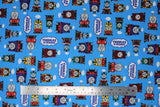 Flat swatch light blue fabric (light blue fabric with full colour character trains allover in multi directions with "Thomas & Friends" logo tossed)