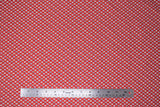 Flat swatch primary chain fabric (red fabric with diagonal lines of white diamonds with squares of primary colour within all arranged in a chain look pattern)