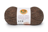 A ball of Lion Brand Touch of Alpaca yarn in wood shade on white background (medium/dark brown with dark grey marled look)