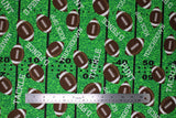 Flat swatch touchdown fabric (green faux football field look fabric with black yard lines and tossed brown/white cartoon footballs allover and "Touchdown" "Tackle" etc. text in white tossed)