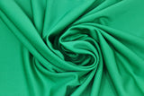 Swirled swatch emerald green spandex fabric