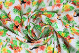 Swirled swatch Birds fabric (white fabric with red parrots, black toucans, and green/yellow/red tropical style birds repeated all with coloured floral and green leaves underneath)
