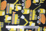 Flat swatch trucks fabric (black fabric with cartoon yellow, orange, and white construction vehicles and trucks, tractor, cement truck, digger)