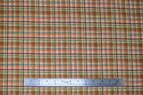 Flat swatch light brown plaid fabric (light brown plaid squares with dark brown, red, and green plaid lines)