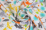 Swirled swatch Woodland Creatures fabric (white fabric with tossed doodle/cartoon style deer, foxes, racoons, squirrels, and tossed leaves, greenery etc. all in yellow, orange, teal, green, grey and charcoal shades)