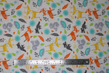 Flat swatch Woodland Creatures fabric (white fabric with tossed doodle/cartoon style deer, foxes, racoons, squirrels, and tossed leaves, greenery etc. all in yellow, orange, teal, green, grey and charcoal shades)