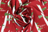 Swirled swatch Christmas printed fabric in Snowy Trees on Red