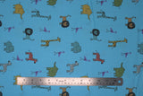 Flat swatch light blue zoo animals fabric (blue fabric with small drawn style zoo animals in full colour allover lions, giraffes, elephants, zebras, etc.)